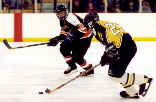 Lee Allen is pursued in the neutral zone.