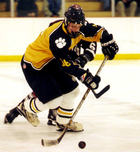 Milton Carter keeps a Pirate away from the puck.