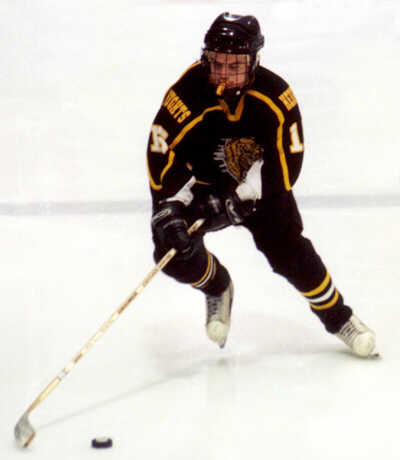 Pat Collins stickhandles into the opponent's zone.