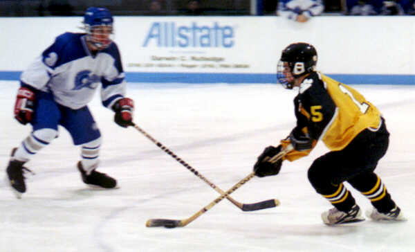 Pat Collins challenges a Trinity defenseman.