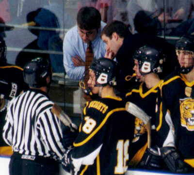 Coaches Steve Bogas and Kirk Guenther confer with a referee.