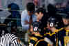 Coaches Steve Bogas and Kirk Guenther confer with a referee.