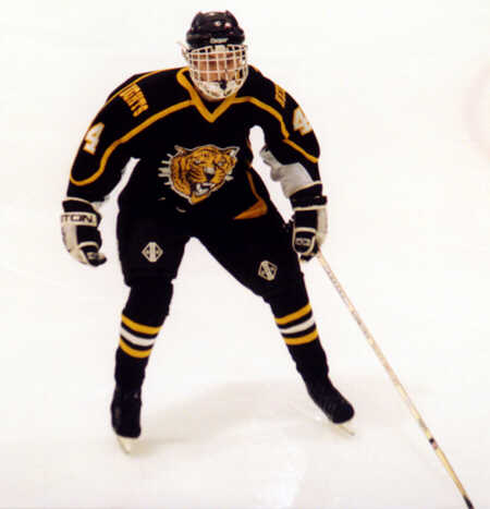 Jeff Houser forechecks for the Tigers.