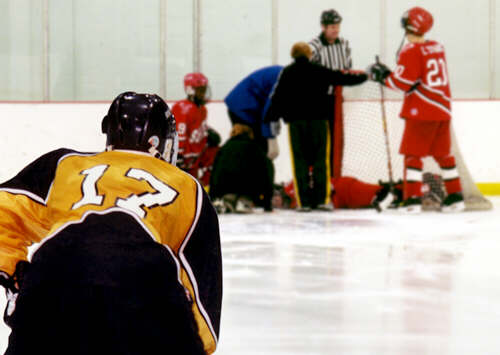 Brendon Benner looks on as the medical staff attends to an injury.