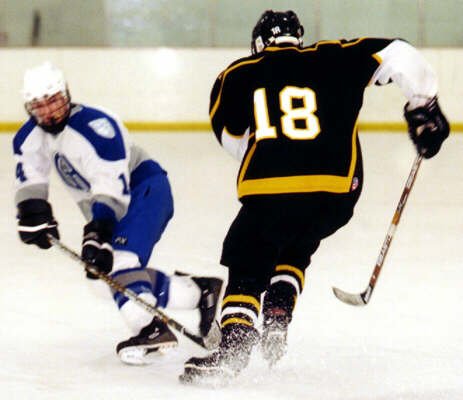 Mike Ruflin steps past a defenseman.