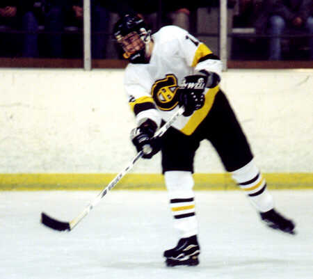 Andrew West passes the puck.