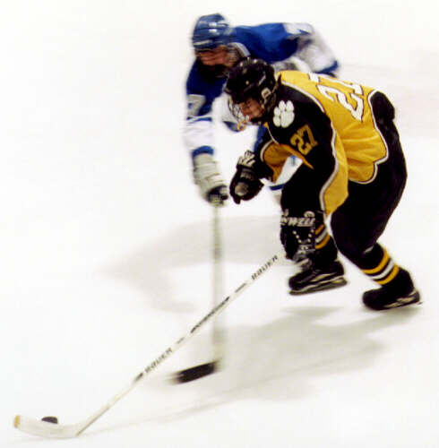 Andrew West dodges a poke check.