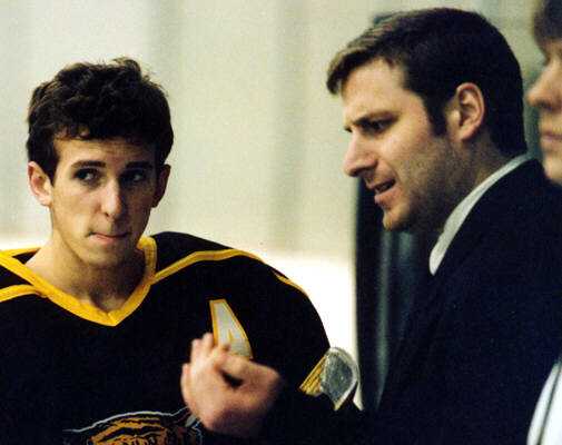 Eric Aber confers with Head Coach Kirk Guenther before a game.
