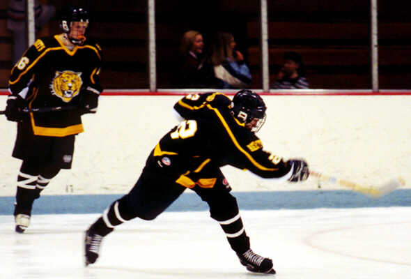 Milton Carter watches Eric Aber's slapshot.