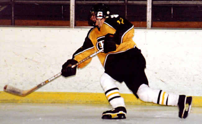 Brendon Benner fires the puck into the Lake Catholic zone.