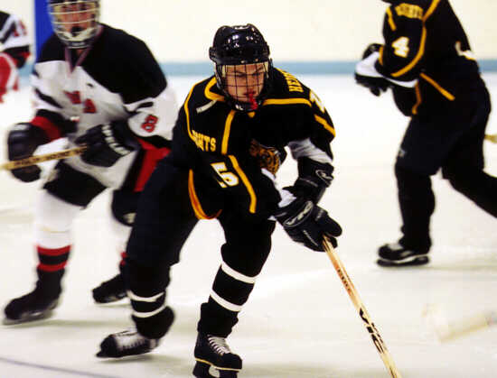 Pat Collins concentrates on the puck amid a flurry of action.