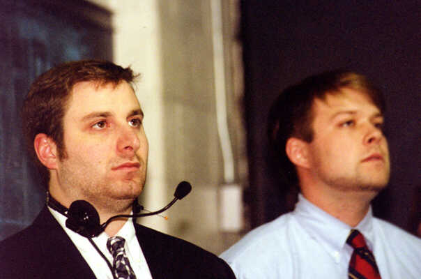 Head Coach Kirk Guenther and Assistant Coach Dave Boehm listen to the national anthem.