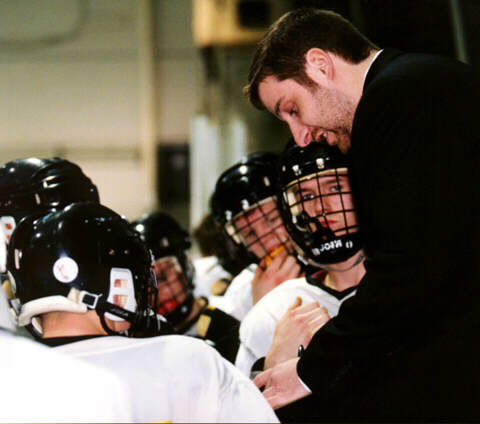 Head Coach Kirk Guenther draws up a play during a Tiger timeout.
