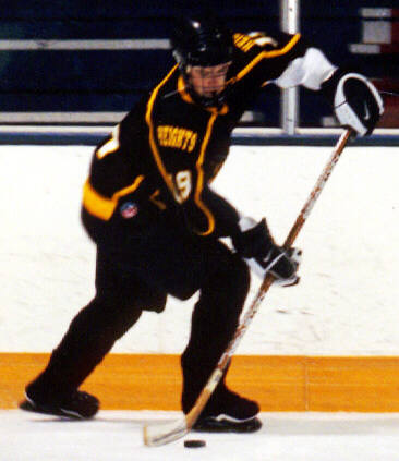 Jeff Hindulak controls the puck along the boards.