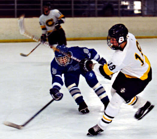 Mike Ruflin slips a pass through a Trinity Trojan.