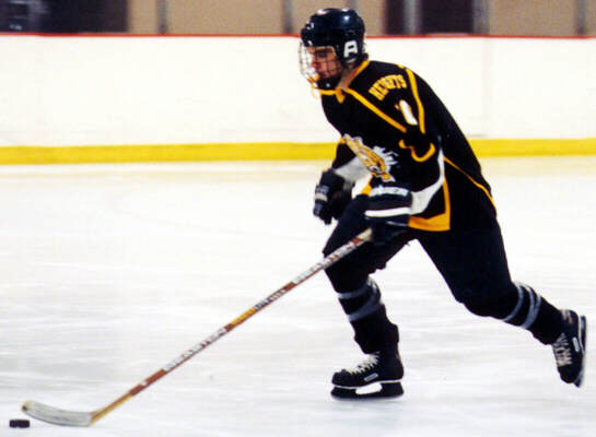 Doug Turner carries the puck.