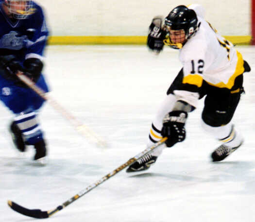 Andy West spears a loose puck.